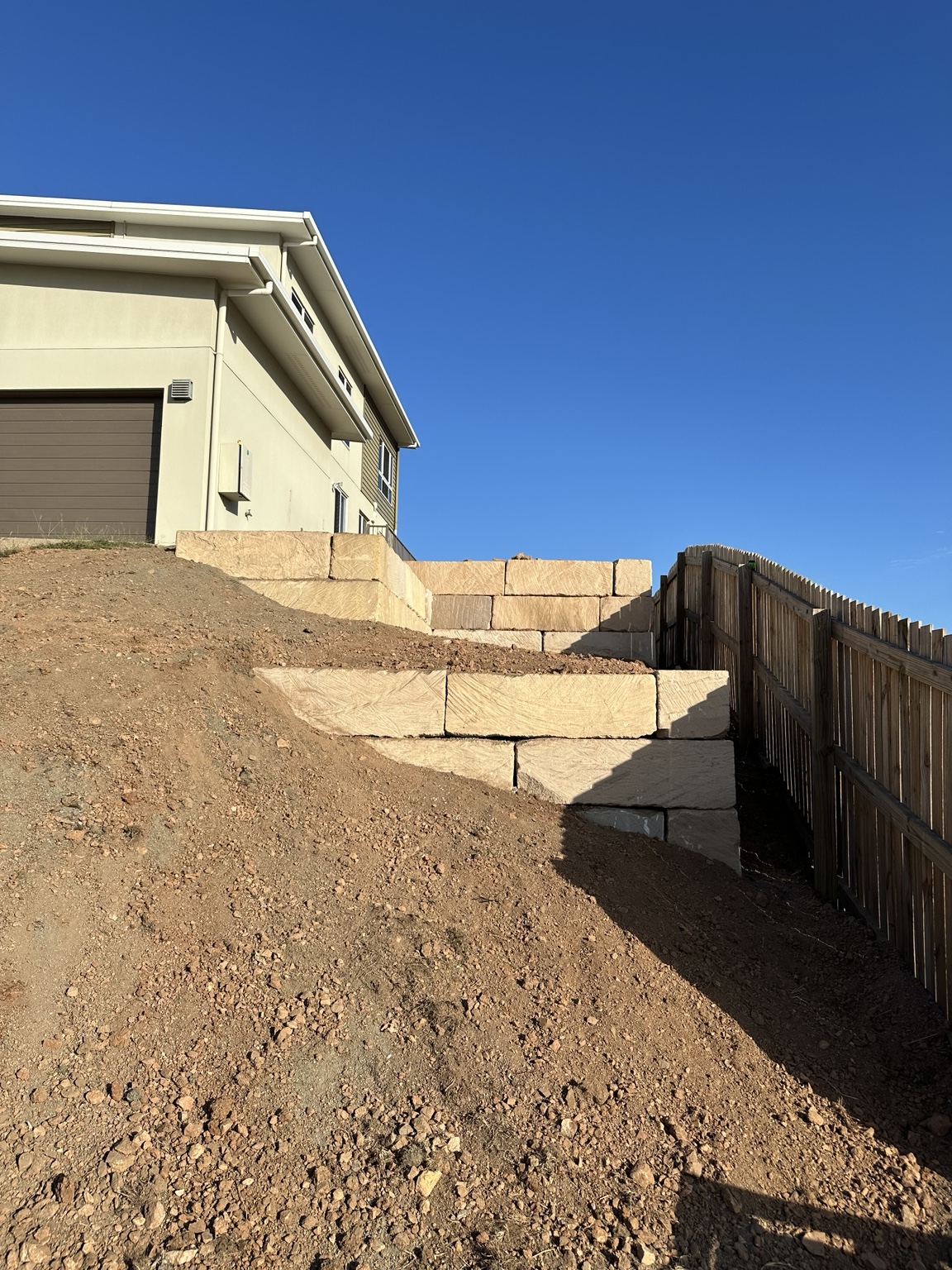 Earthworks beside a stepped retaining wall
